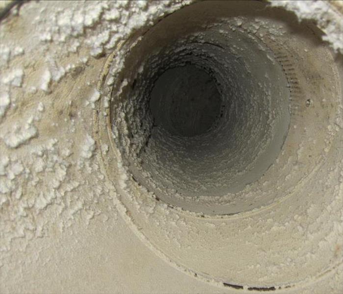 inside of an HVAC duct filled with dust and dirt