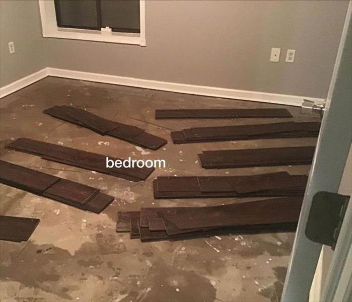 empty bedroom the floor is wet, wooden planks are on the floor. Concept of water damage in a bedroom 